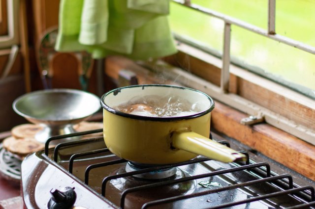 Stainless steel cooking pot boiling on the stove