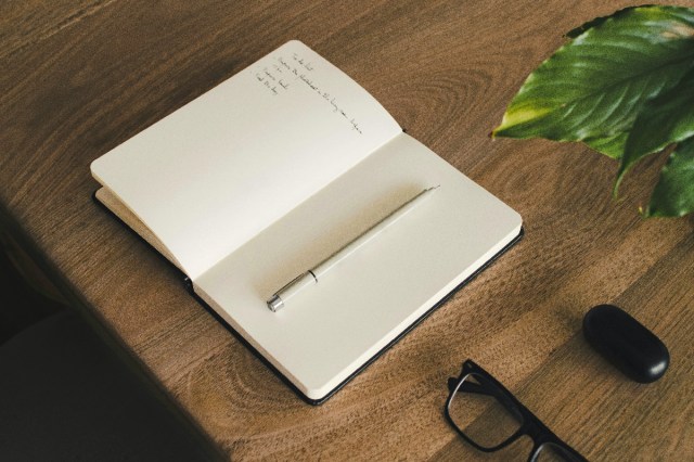 An open notebook on a wooden table