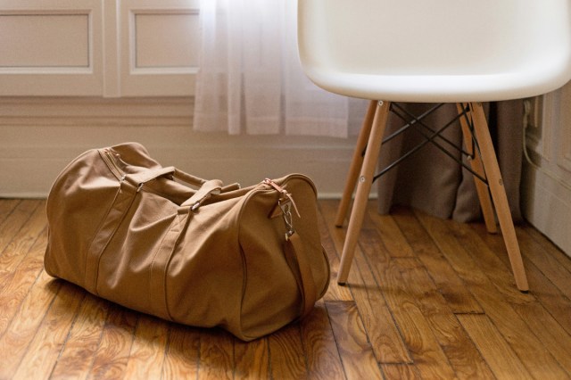 A brown duffel bag laying on the floor