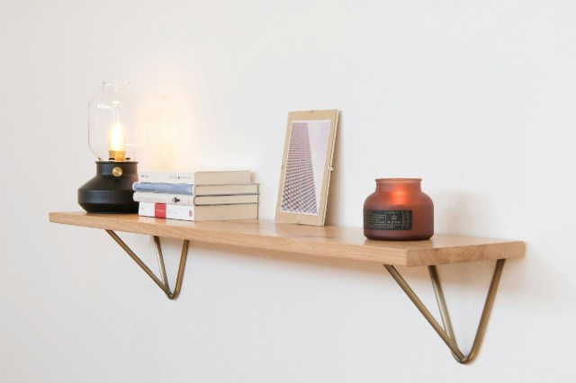 Home decor organized on a floating wooden shelf