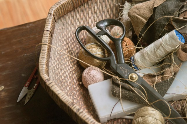 A wicker basket filled with sewing supplies