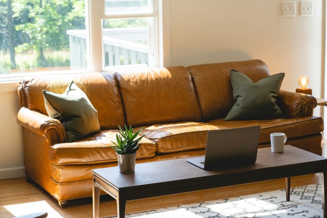 A living room with a brown leather couch