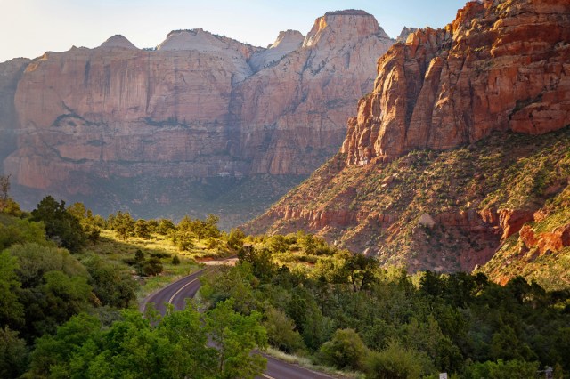 A road winding through mountains on a sunny day 