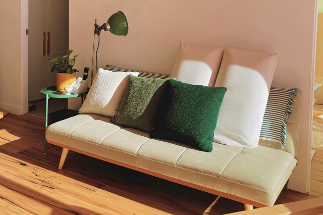 A colorful couch in a living room 