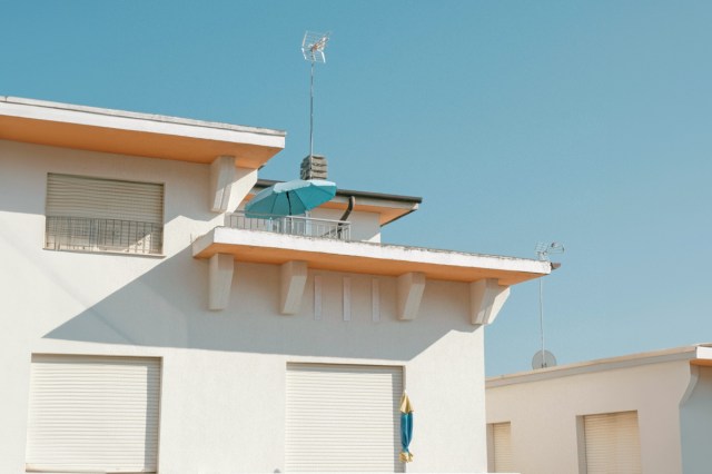 A tall white building against a blue sky 