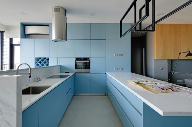 A modern kitchen with blue cabinets