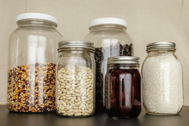 A group of glass jars filled with ingredients 