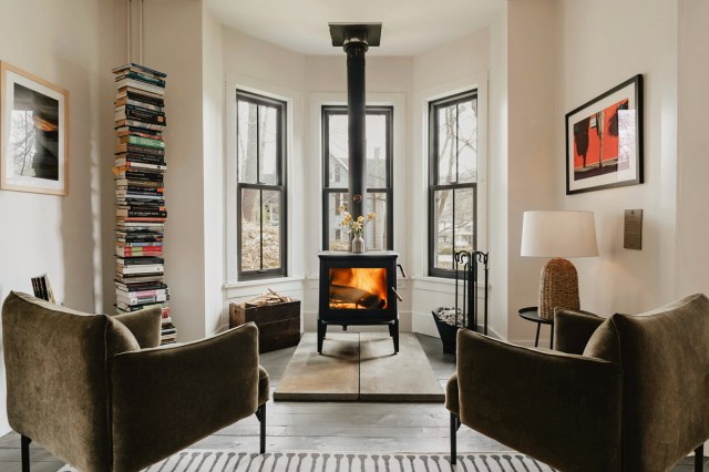 A living room with two chairs facing a fireplace