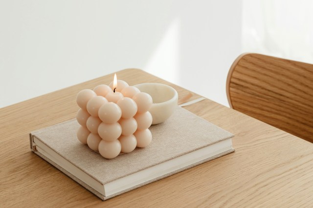 A candle on a wood table