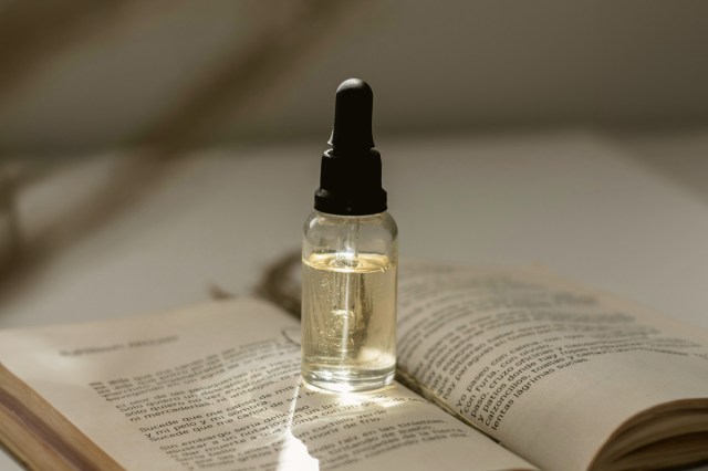 A dropper bottle on a book 