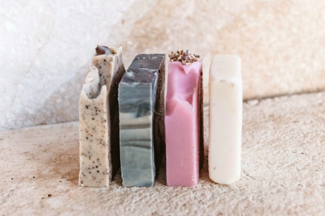 Multiple bars of soap lined up in a bathroom 