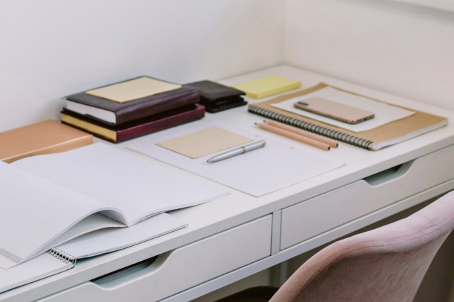 A desk with lots of notebooks