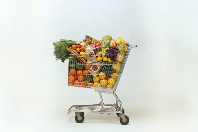 A grocery cart packed with produce