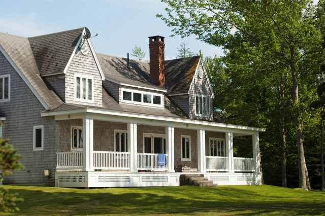 White and brown house with a large porch